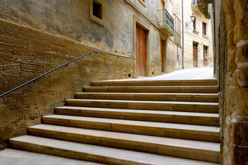 Steps up an empty, quiet narrow street in a spanish village Calaceite, Teruel, Aragon, Spain 