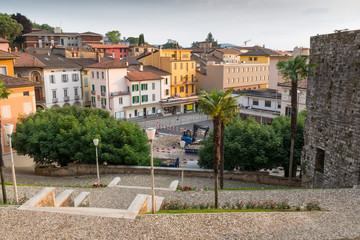 Urbanization works in the historic center of a Swiss city. Mendrisio, square del Ponte in front of the church of Santi Cosma e Damiano at sunset
