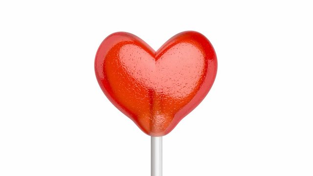 Lollipop in shape of heart, spins on white background