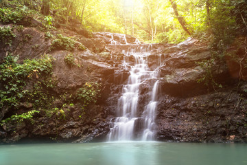 beautiful small waterfall in the wild with sun light,nature
