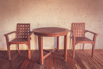 wooden chair and table in vintage filter.