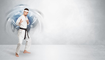 Fototapeta premium Young businessman in suit fighting with empty wall background 