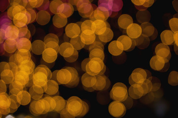 Abstract blurred and bokeh of reflection lighting of yellow led light bubs on black background.