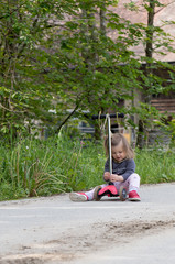 Fototapeta premium Scooter. Baby. Girl. Sitting. Forest. Cute