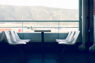 Side view on the seats with table on the deck of the ferryboat on the seaside travel ship