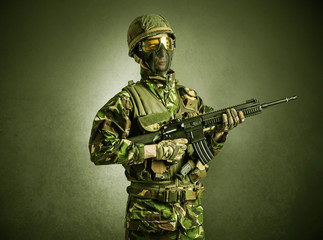 Soldier agent in a dark room with arms on his hand and gas mask
