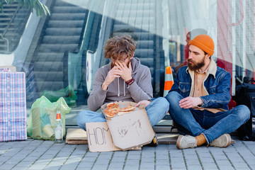 Homeless beggar telling his story young handsome beard man listening with pity compassion emotion...