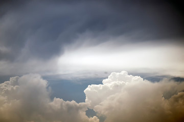 Naklejka na ściany i meble Big cumulonimbus on blue sky. Cumulus, stratocumulus, stratus, altocumulus, nimbostratus. Dramatic sky with stormy clouds