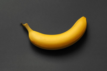 banana on a dark background. one ripe banana.