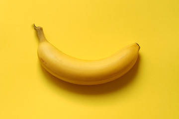 banana on yellow background. one ripe banana. © Sergey