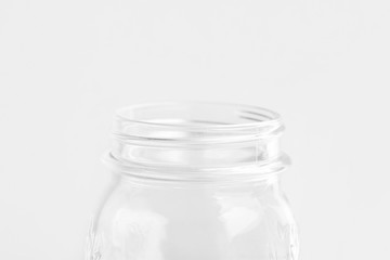 Glassware crystal mason jar on white wall background. Reusable materials plastic-free alternatives zero waste environmental protection food storage concept. Mockup poster with copy space