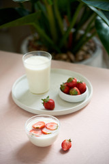 fresh organic yogurt with strawberries on table