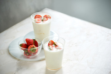Fresh strawberry on a glass with dessert yogurt and strawberry  on white background