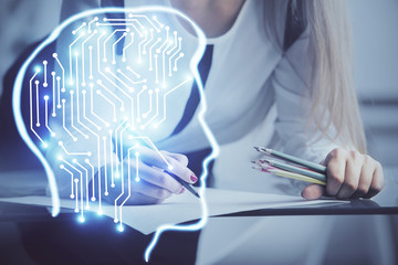 Multi exposure of woman's writing hand on background with brain hud. Concept of learning.