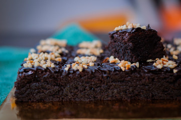 Chocolate Cake Brownie Squares Drizzled With Chocolate Nutella and Walnuts. Closeup view, selective focus