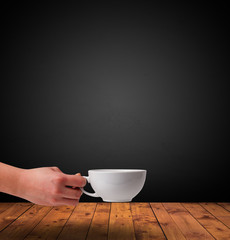 Cup of drink on wooden table with dark background
