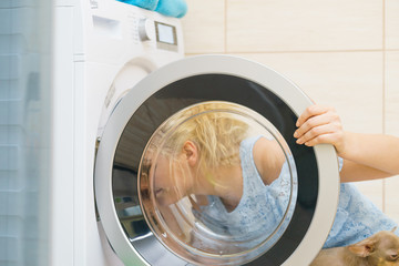 Woman looking inside of washing machine