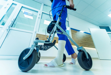 Patient on rollator with hand brakes moving in hospital