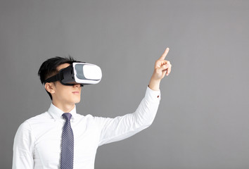 Portrait of young businessman in vr goggles