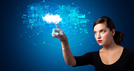 Woman touching hologram projection displaying information from cloud based system
