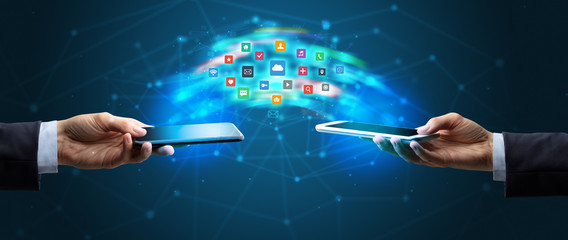 Two mobile phones syncing applications concept