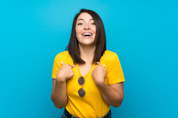 Young Mexican woman over isolated blue background with surprise facial expression