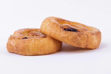 Detail plan of two rolls of freshly baked puff pastry with honey on top