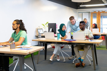 Business people working together at desk in a modern office