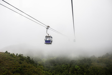 ngong ping 360 cable car on the green mountain landscape view in the rain season hong Kong