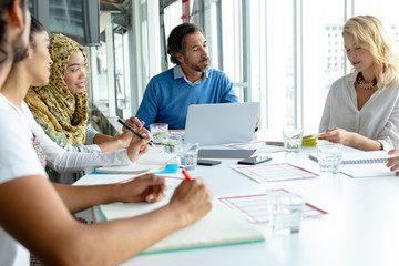 Business people discussing with each other in meeting at conference room in a modern office