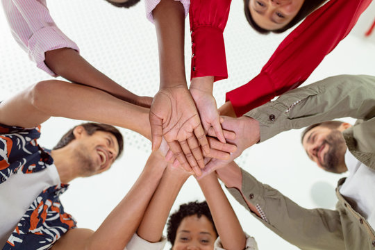 Business people forming hand stack in a modern office