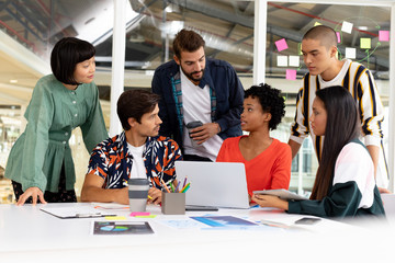 Business people discussing over laptop in the conference room