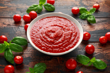 Homemade tomato Passata in white bowl on wooden table