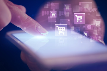 Finger touching phone with online shopping concept and dark background
