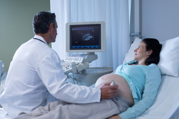 Fototapeta na wymiar Doctor doing ultrasound scan for pregnant woman in hospital