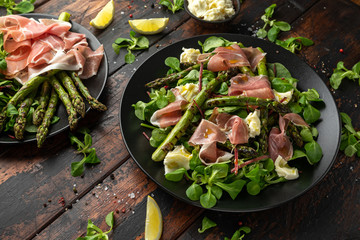 Grilled Asparagus, parma ham salad with mozzarella cheese and green vegetables