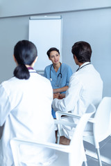 Fototapeta premium Diverse medical team sitting and discussing at the table