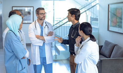 Medical team of doctors talking with each other in lobby