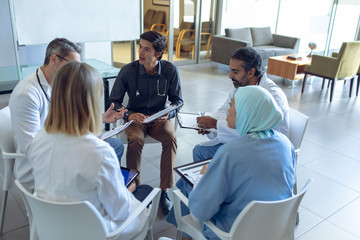 Medical team discussing with each other in hospital