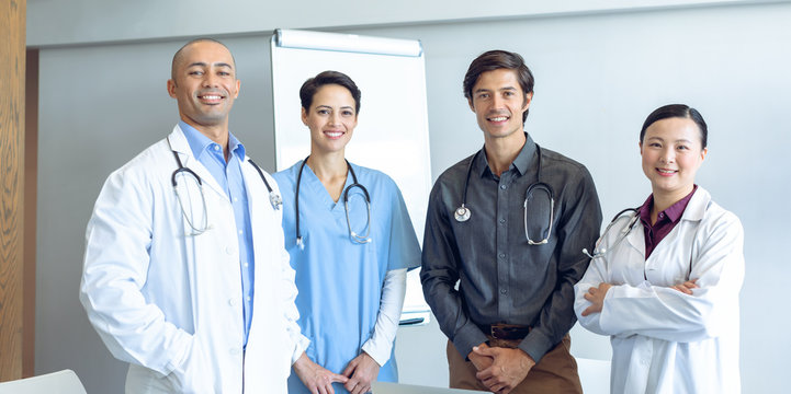 Happy medical team looking at camera in the hospital
