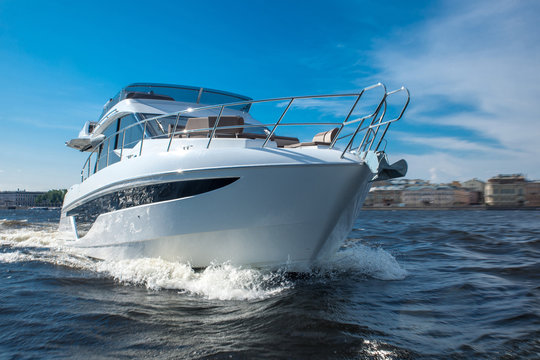 white yacht at river in city, luxury lyfe