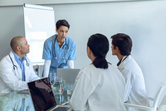 Medical team sitting and discussing with each other at the table