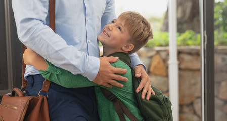 Fototapeta premium Son embracing his father in a comfortable home