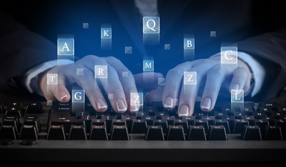 Business woman typing on keyboard with letters around
