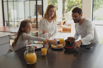 Caucasian family having food at dining table 