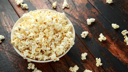 bowl of salty popcorn on wooden table