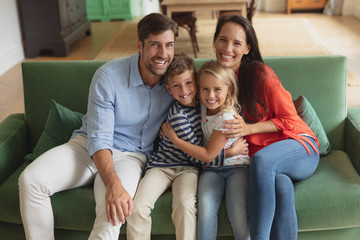 Family sitting together on sofa in living room art home