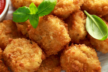 Fried Mac, macaroni and Cheese Bites in breadcrumbs with ketchup sauce