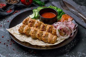 Lula kebab chicken on black plate