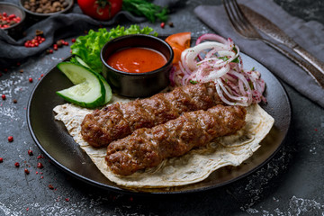 Lamb Lula kebab on black plate